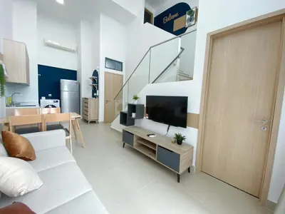 a living room with a couch and a tv and a table at The Colony By Infinitum By Awesomestay in Kuala Lumpur
