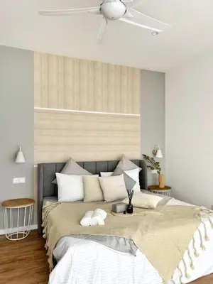 a bedroom with a large bed with a ceiling at Quill Residences Kuala Lumpur in Kuala Lumpur