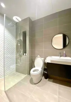 a bathroom with a toilet and a sink and a shower at Quill Residences Kuala Lumpur in Kuala Lumpur