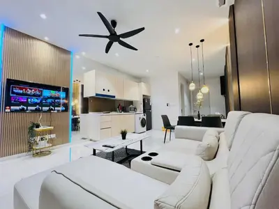 a living room with a white couch and a ceiling fan at Quill Residences Kuala Lumpur in Kuala Lumpur