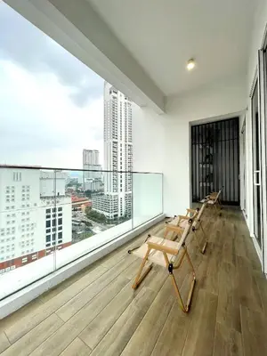 a room with a balcony with a view of a city at Quill Residences Kuala Lumpur in Kuala Lumpur