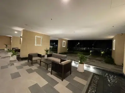 a lobby with a couch and chairs and a pool at Inspirasi Mont Kiara 3 Rooms Balcony Free WIFI & Carpark By The Homez in Kuala Lumpur