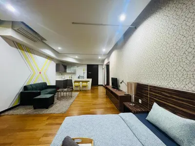 a living room with a couch and a table at Regalia Residence And Suites By The Relaxstay in Kuala Lumpur
