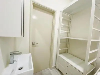 a white bathroom with a sink and a shower at Arte Mont Kiara By The Relaxstay in Kuala Lumpur