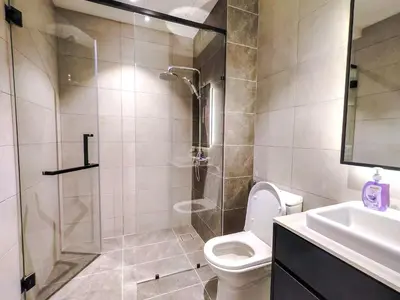 a bathroom with a shower and a toilet and a sink at AXON Residence Kuala Lumpur in Kuala Lumpur