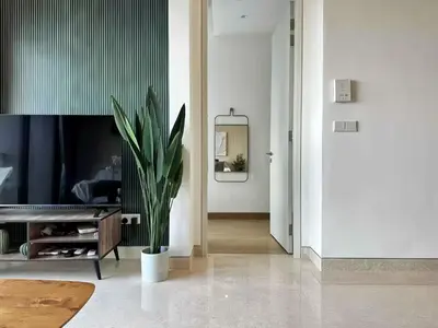 a living room with a potted plant and a television at Lucentia Residence Bukit Bintang in Kuala Lumpur