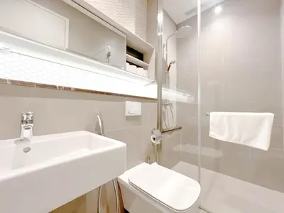 a white bathroom with a sink and a toilet at Lucentia Residence Bukit Bintang in Kuala Lumpur