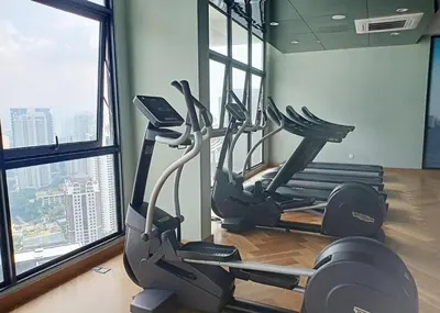a gym with two exercise bikes in a room at OOAK residence in Kuala Lumpur