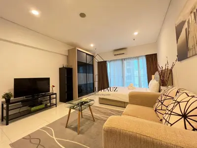 a living room with a couch and a bed and a television at Mercu Summer Suites KLCC by Veedu Hauz in Kuala Lumpur