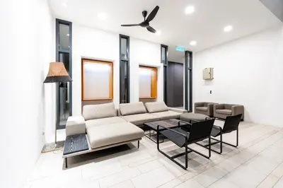 a living room with a couch and a table and chairs at Harmony Luxury Suites At Lucentia Bukit Bintang City Center in Kuala Lumpur