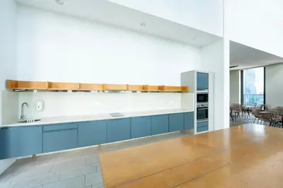 a kitchen with blue cabinets and a counter top at Harmony Luxury Suites At Lucentia Bukit Bintang City Center in Kuala Lumpur