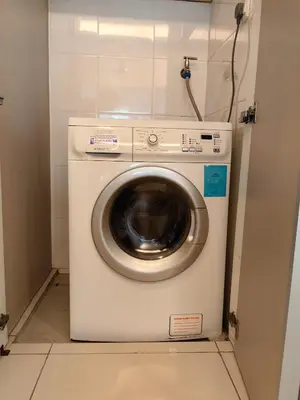 a washer and dryer in a small room at 703 KLCC 5 minutes to Alor Street Ceylon Pavilion 3 Room Apt for 10 Pax in Kuala Lumpur