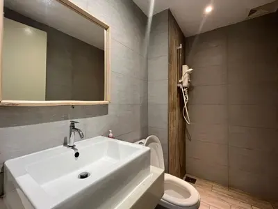 a bathroom with a sink and a toilet and a mirror at Arte Plus Ampang By The Relaxstay in Kuala Lumpur