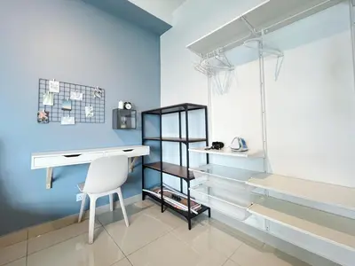a desk and chair in a room with blue walls at Arte Plus Ampang By The Relaxstay in Kuala Lumpur