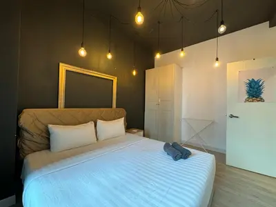 a bedroom with a bed with a blue bag on it at Arte Plus Ampang By The Relaxstay in Kuala Lumpur