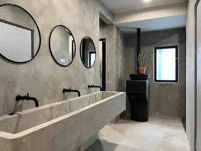 a bathroom with a large tub and three mirrors at The Freedom Club Hostel KL in Kuala Lumpur