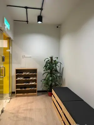 a room with a bed and a plant in it at The Freedom Club Hostel KL in Kuala Lumpur