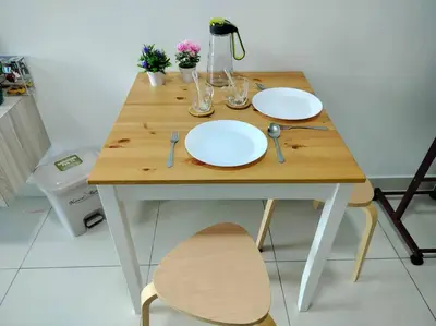 a wooden table with two white plates on it at Ampang 2-4 pax Studio AmpPoint in Ampang