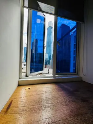 a room with a large window with a view of a city at Bintang Goldhill Guest House in Kuala Lumpur
