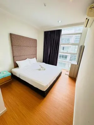 a bedroom with a large bed and a large window at Bintang Goldhill Guest House in Kuala Lumpur