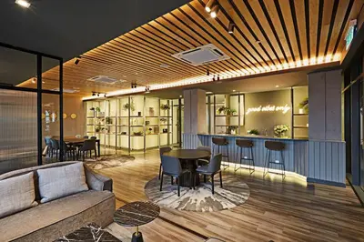 a living room with a couch and a table and chairs at Romantic Log Cabin 2 - Heart of KL, near KLCC/KL Tower in Kuala Lumpur