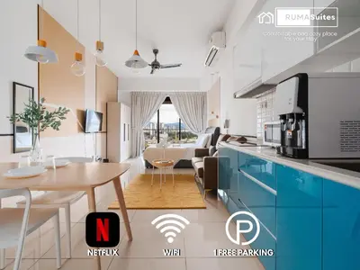 a kitchen and a living room with a table at Cozy Studio near TRX By Rumabnb in Kuala Lumpur