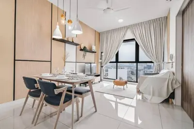 a dining room with a table and chairs at Cozy Studio near TRX By Rumabnb in Kuala Lumpur