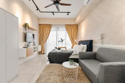 a living room with a couch and a ceiling fan at Cozy Studio near TRX By Rumabnb in Kuala Lumpur