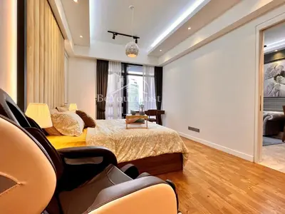 a bedroom with a bed and a table and chairs at Anggun Residences Luxury Suites KL City Center in Kuala Lumpur