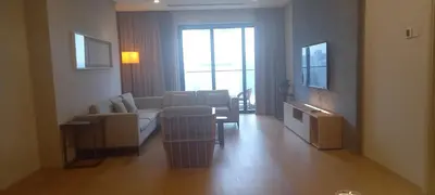 a living room with a couch and a table and chairs at Cozy Apartment with Jacuzzi and Sauna at 188 Suites Klcc in Kuala Lumpur