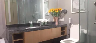 a bathroom with a sink and a toilet and a mirror at Cozy Apartment with Jacuzzi and Sauna at 188 Suites Klcc in Kuala Lumpur