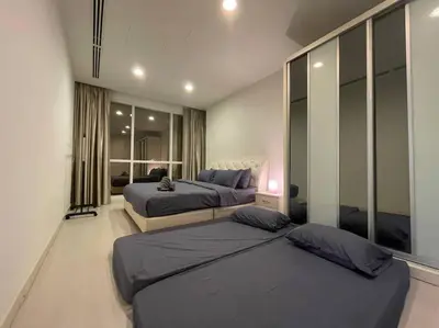a bedroom with two beds and a large window at Binjai 8 Premium Soho, KLCC, nearby LRT by EC in Kuala Lumpur