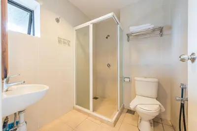 a bathroom with a shower and a toilet and a sink at Menara PGRM By Minsu in Kuala Lumpur
