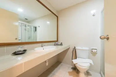 a bathroom with a toilet and a sink and a mirror at Menara PGRM By Minsu in Kuala Lumpur