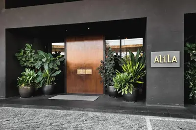 a front door of an office with potted plants at KLSentral-Bangsar-MidValley-2-10pax-Netflix-Balcony-Super Fast Internet in Kuala Lumpur