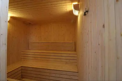 an empty wooden sauna with a light on the ceiling at KLSentral-Bangsar-MidValley-2-10pax-Netflix-Balcony-Super Fast Internet in Kuala Lumpur